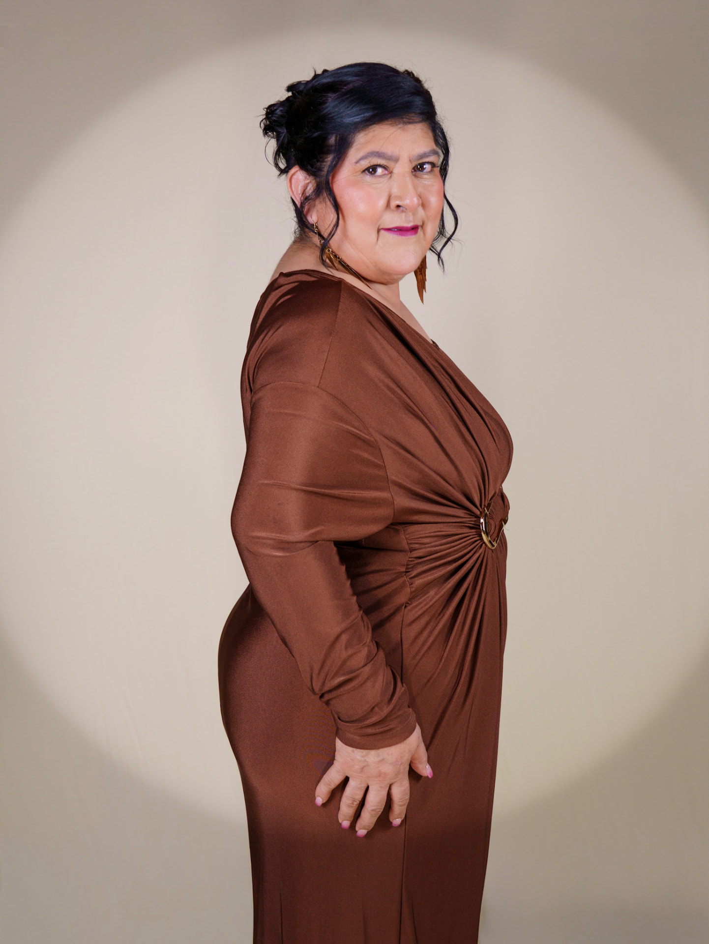 Profile studio portrait in a brown satin gown