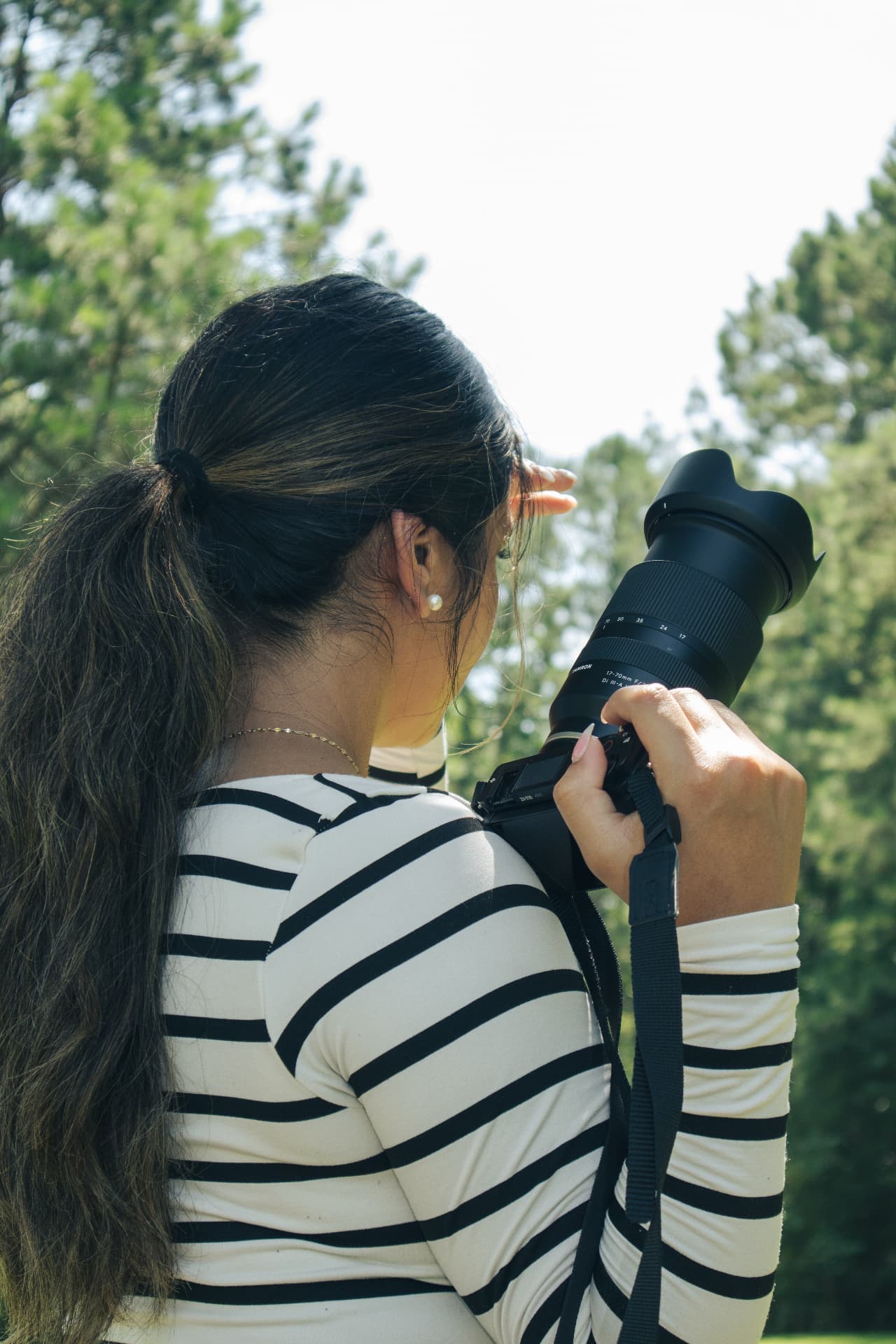 Jenny photographing outdoors among the trees