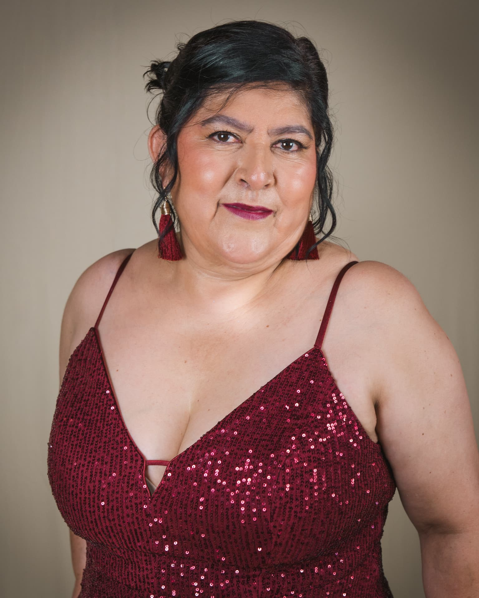 Studio portrait of a woman in a burgundy sequin dress at a Buford, GA photography studio