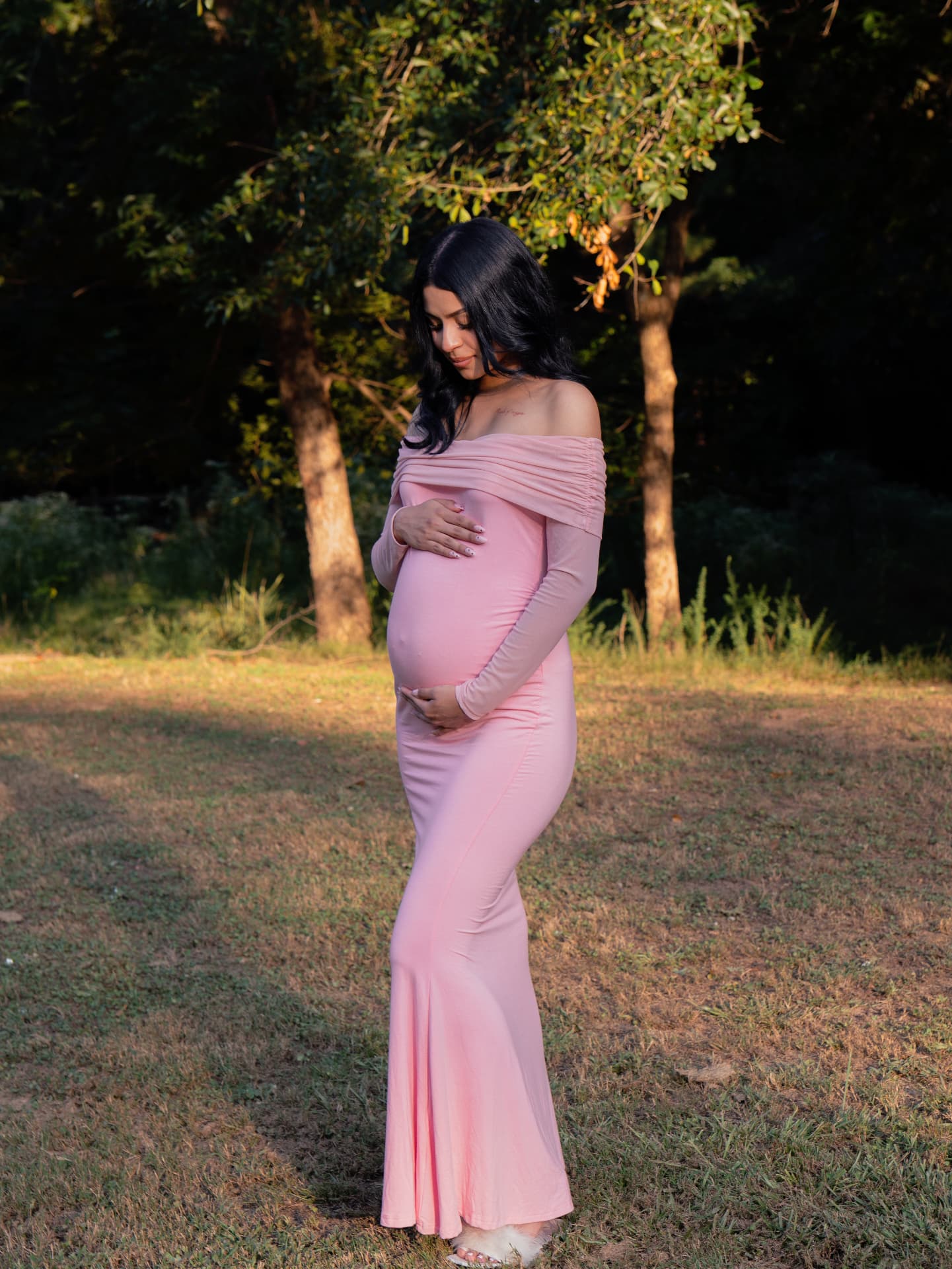 Maternity portrait of an expecting mother in a pink gown in a North Georgia field