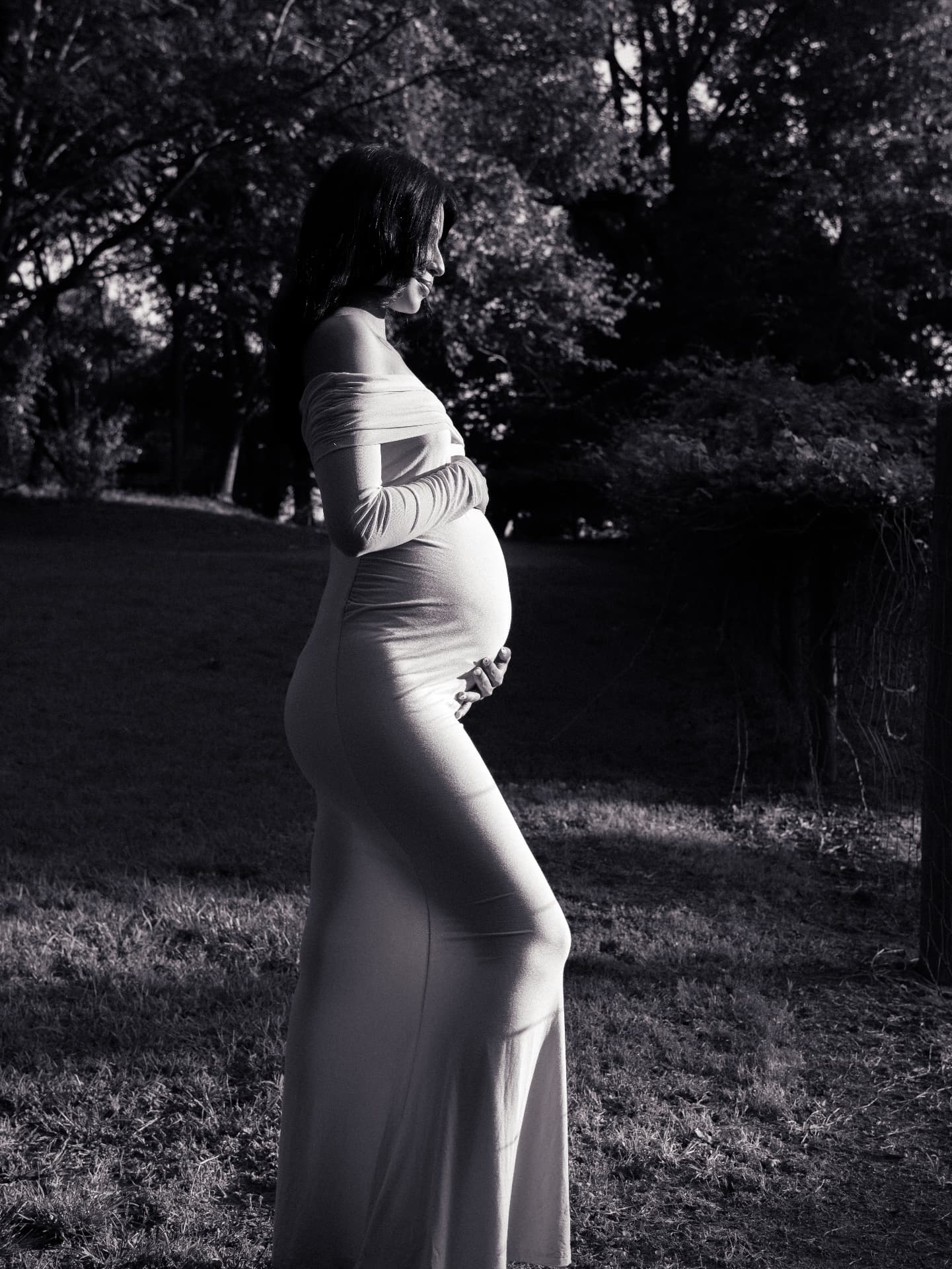 Black and white full-length maternity silhouette in a flowing gown