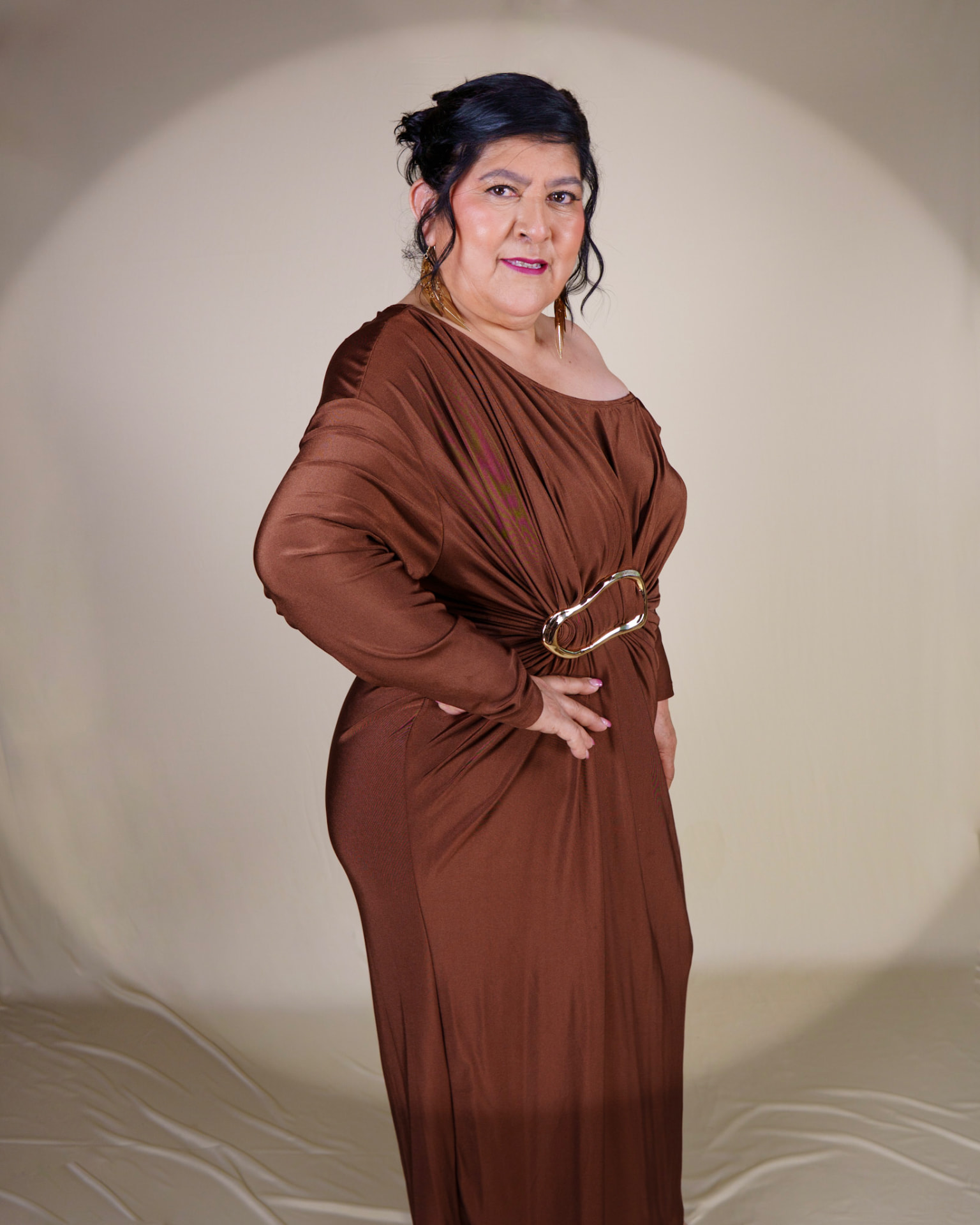 Studio portrait in a draped brown gown