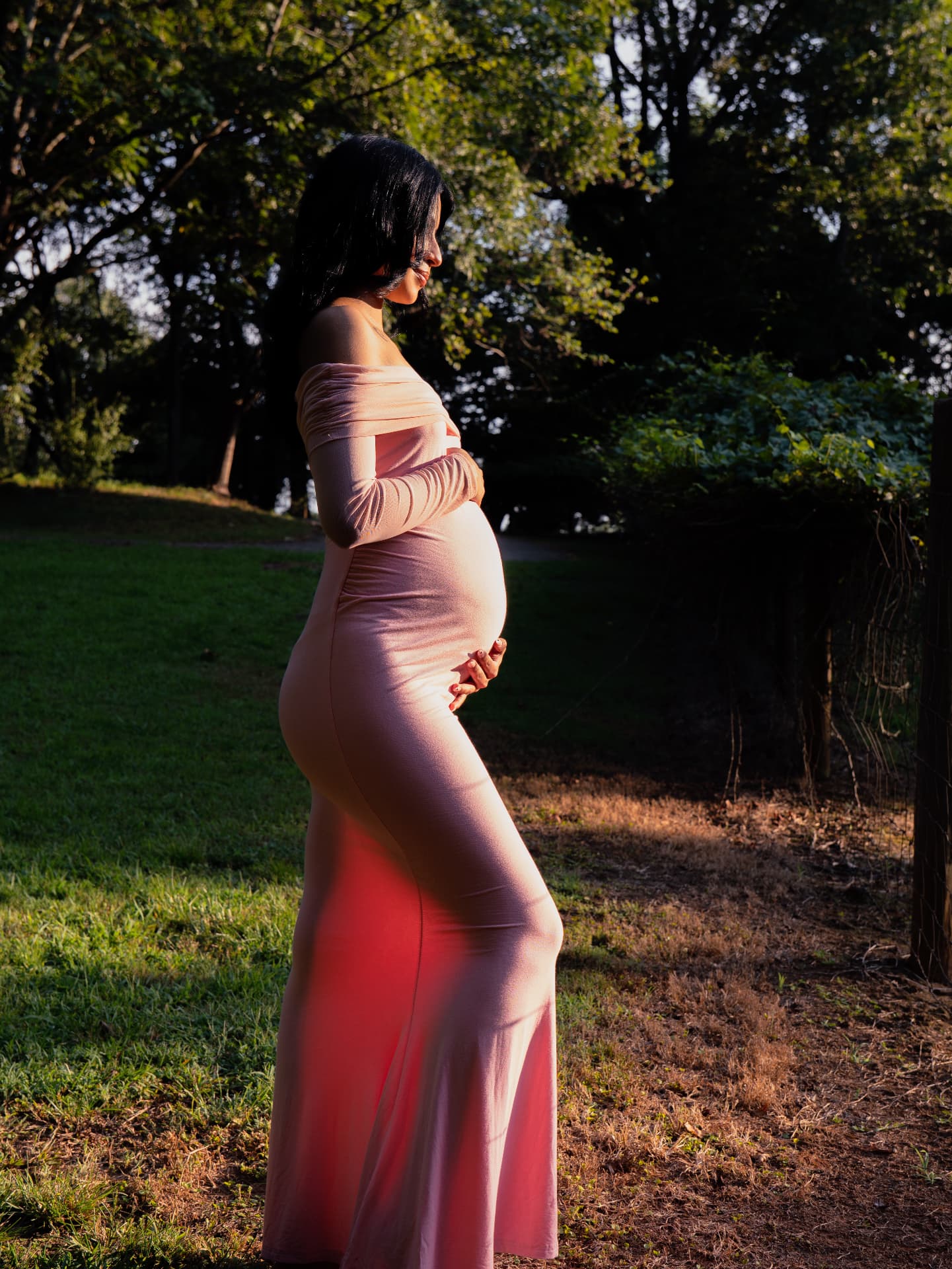 Golden hour maternity profile in a blush gown at a North Georgia park